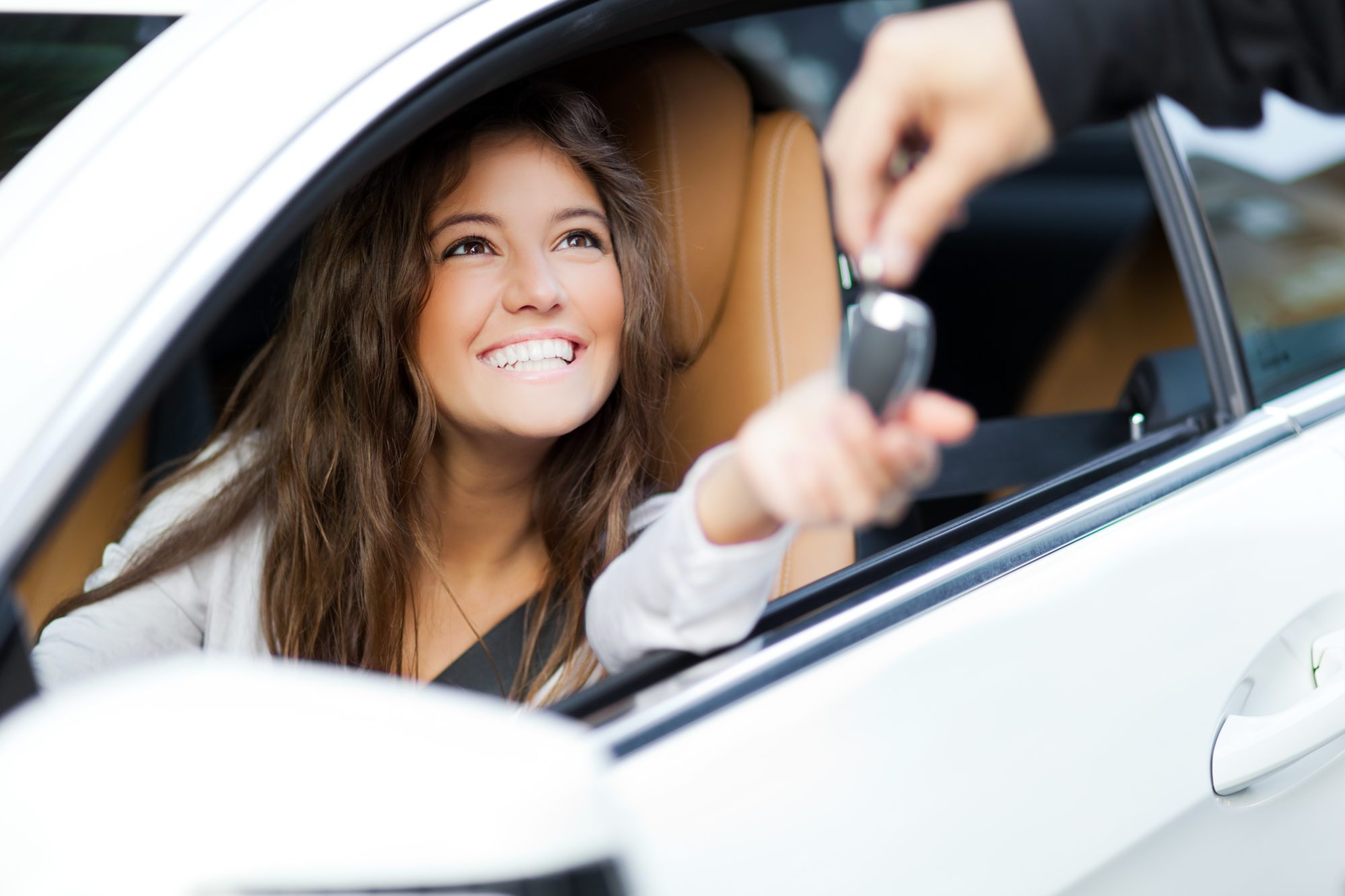Blog - Woman receiving keys of her new car from dealer